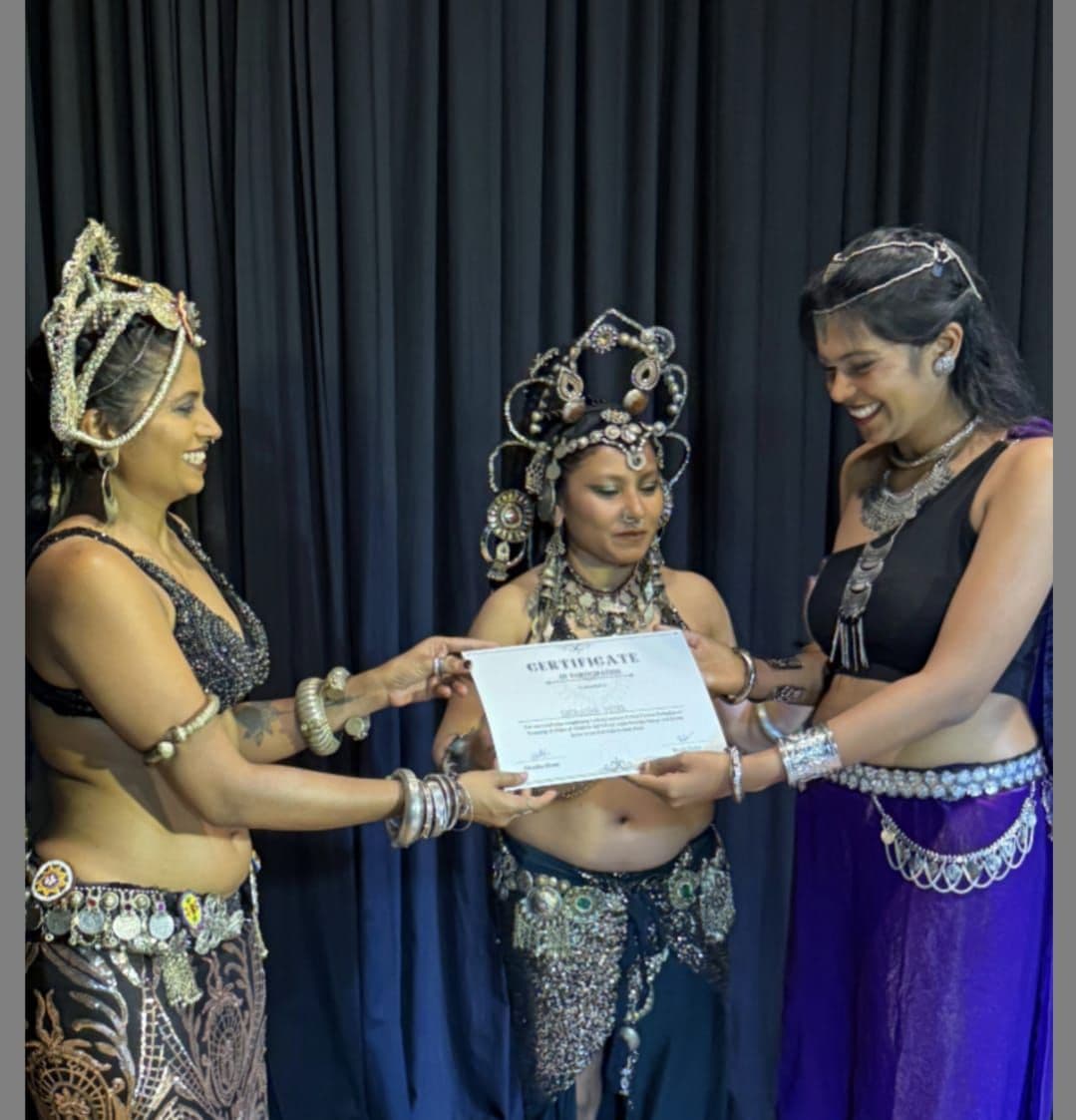 Satavisha receiving a certificate with fellow dancers at Tribal Revival